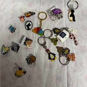 Disney pins and Old Navy key chains. New.